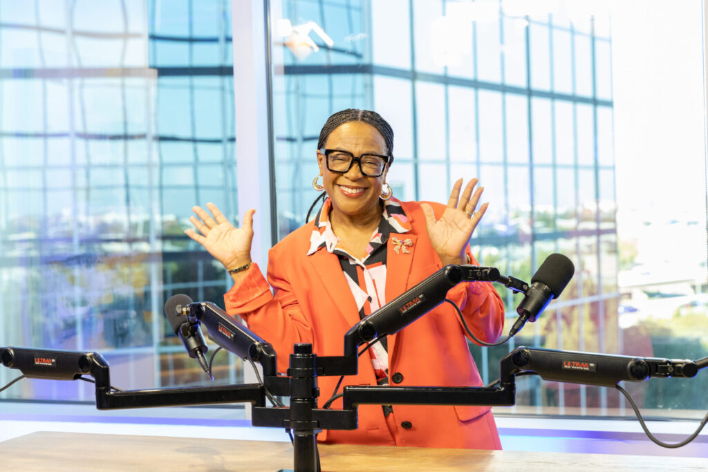 Cynt smiling at the camera during a podcast